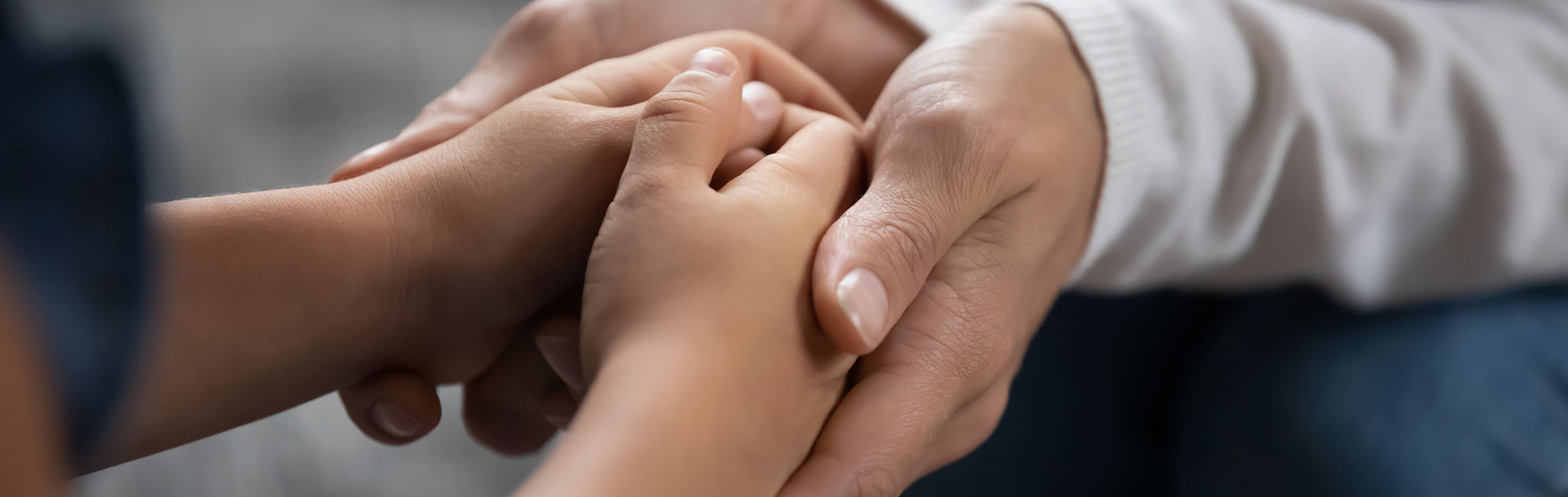adult holding a child's hands