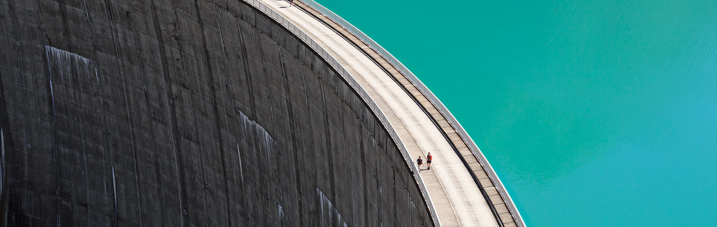 aerial shot of people walking on a reservoir dam