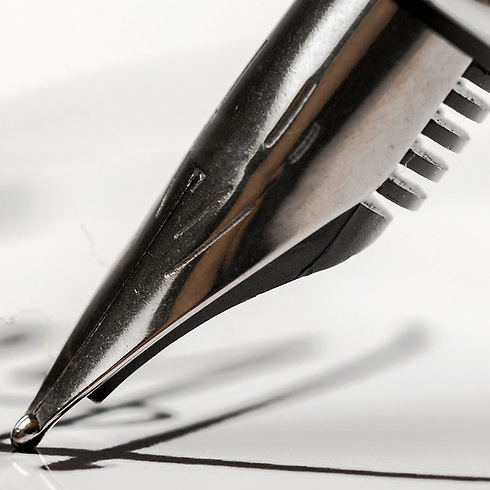 head of a fountain pen writing in cursive