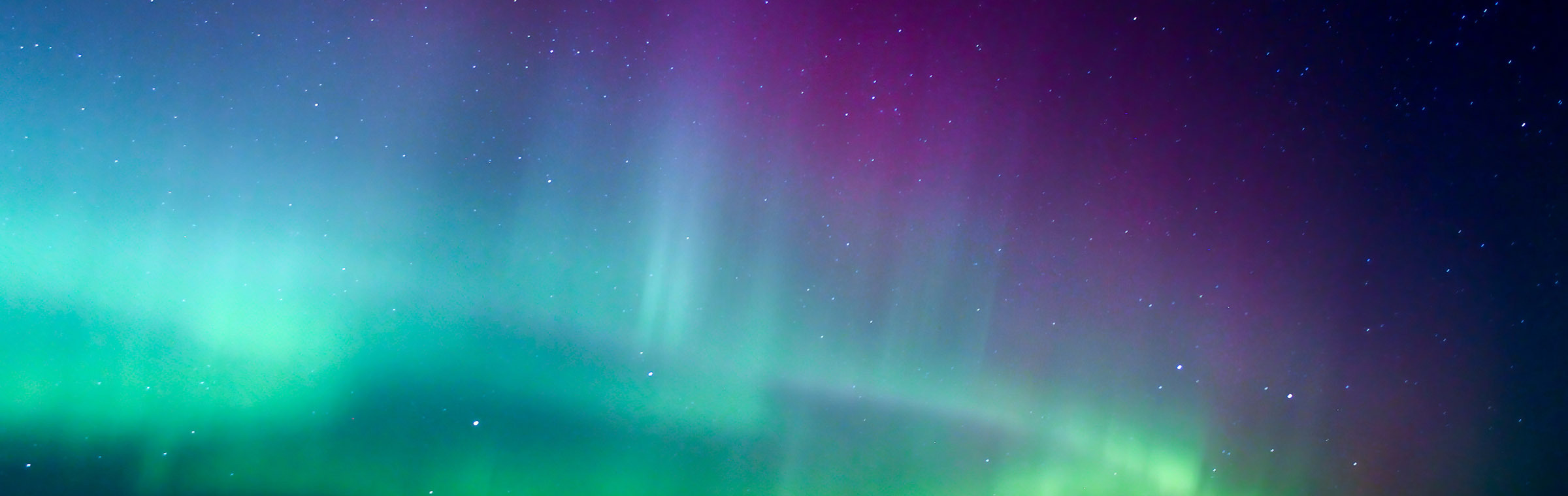 dark sky overhead shining a rainbow of light and colors