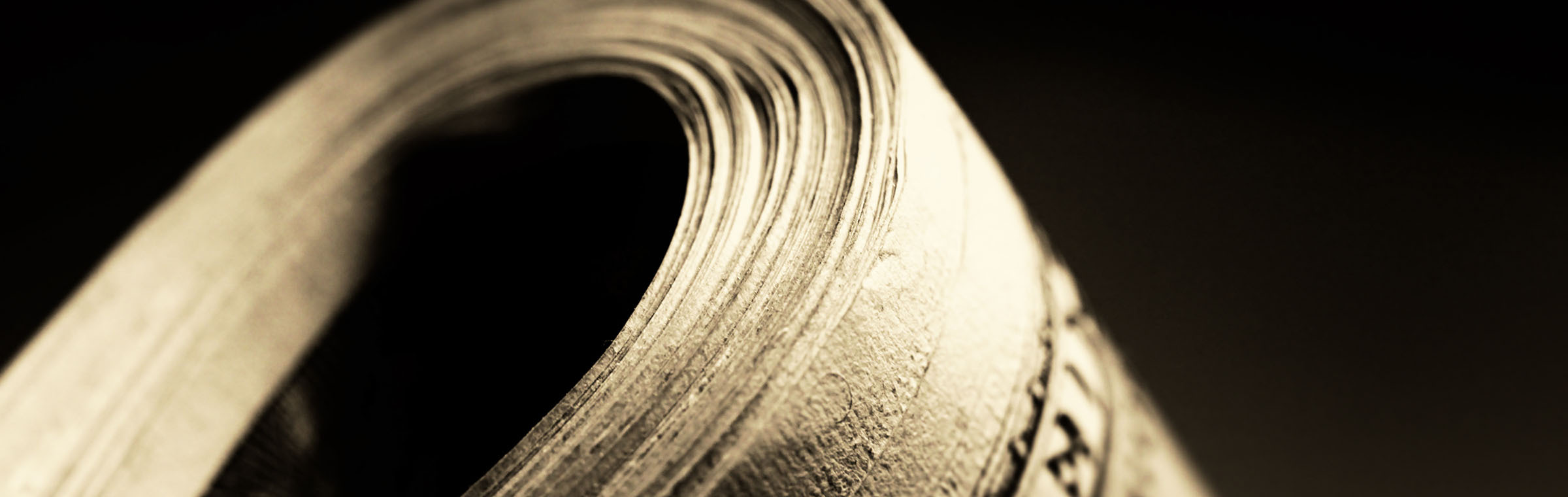 folded dollar bills against a black background