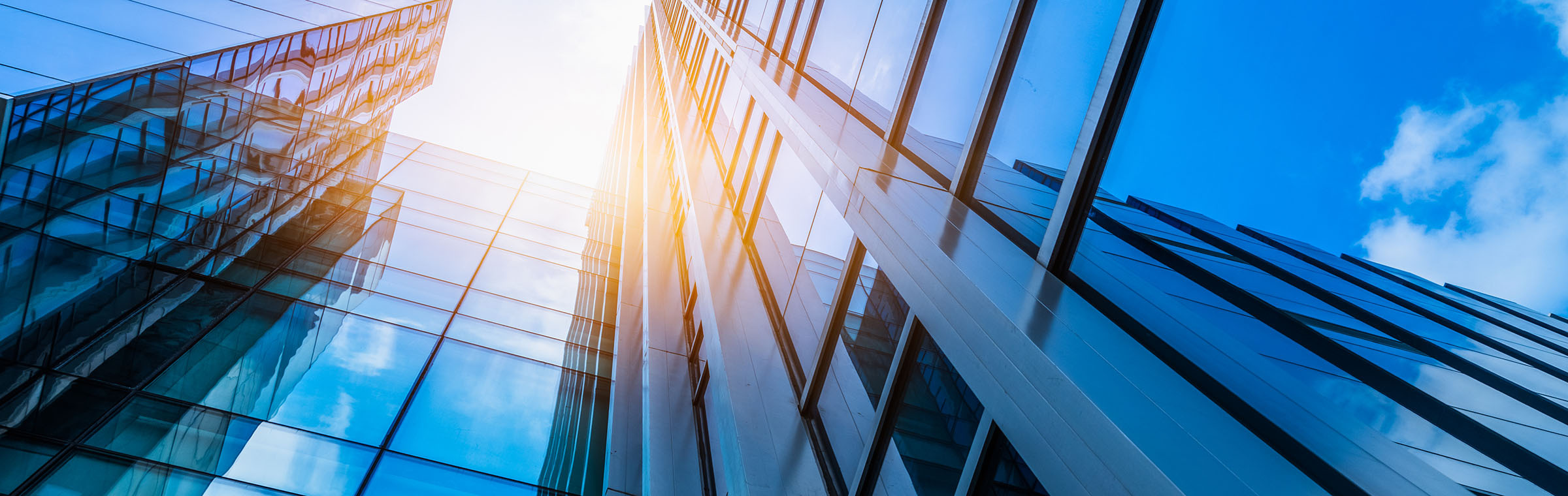 view of glass buildings and the blue sky above